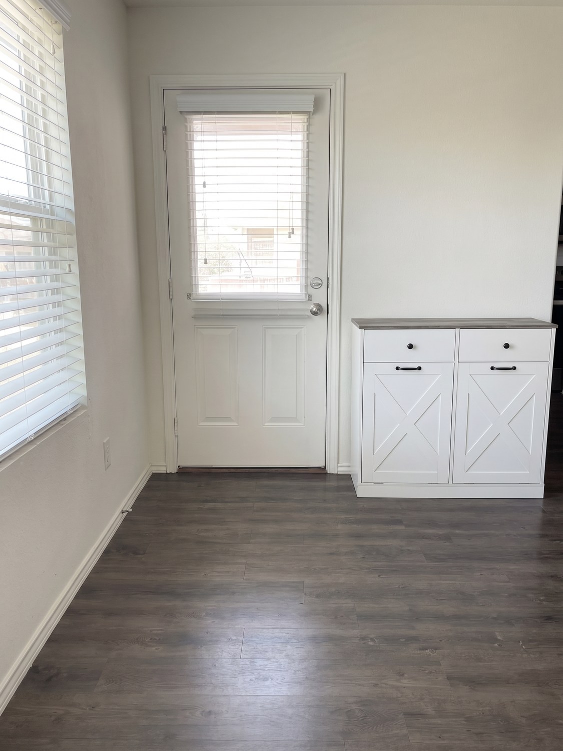 The same entryway cleared, with the finished two-bay console cabinet built and set against the wall.