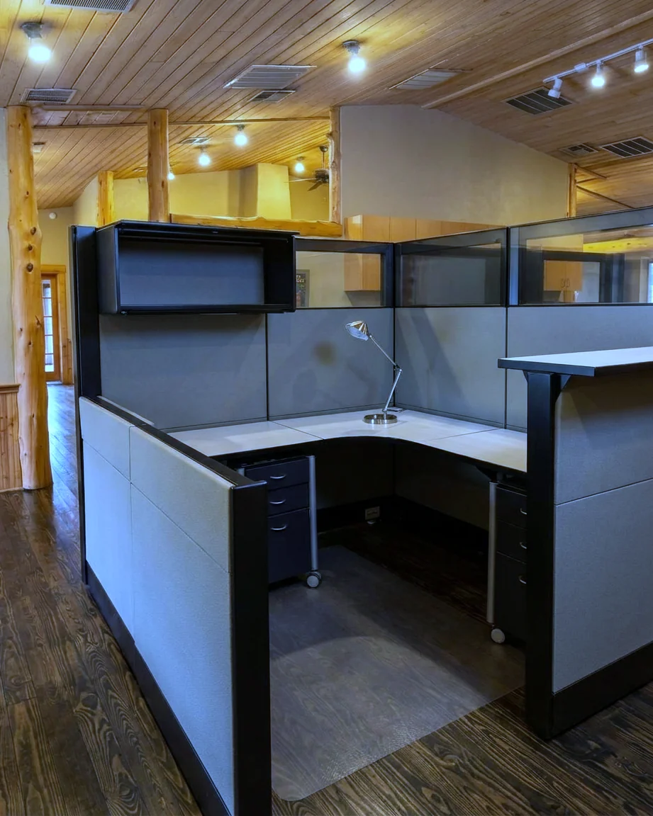 A finished run of grey cubicles on a commercial office floor.