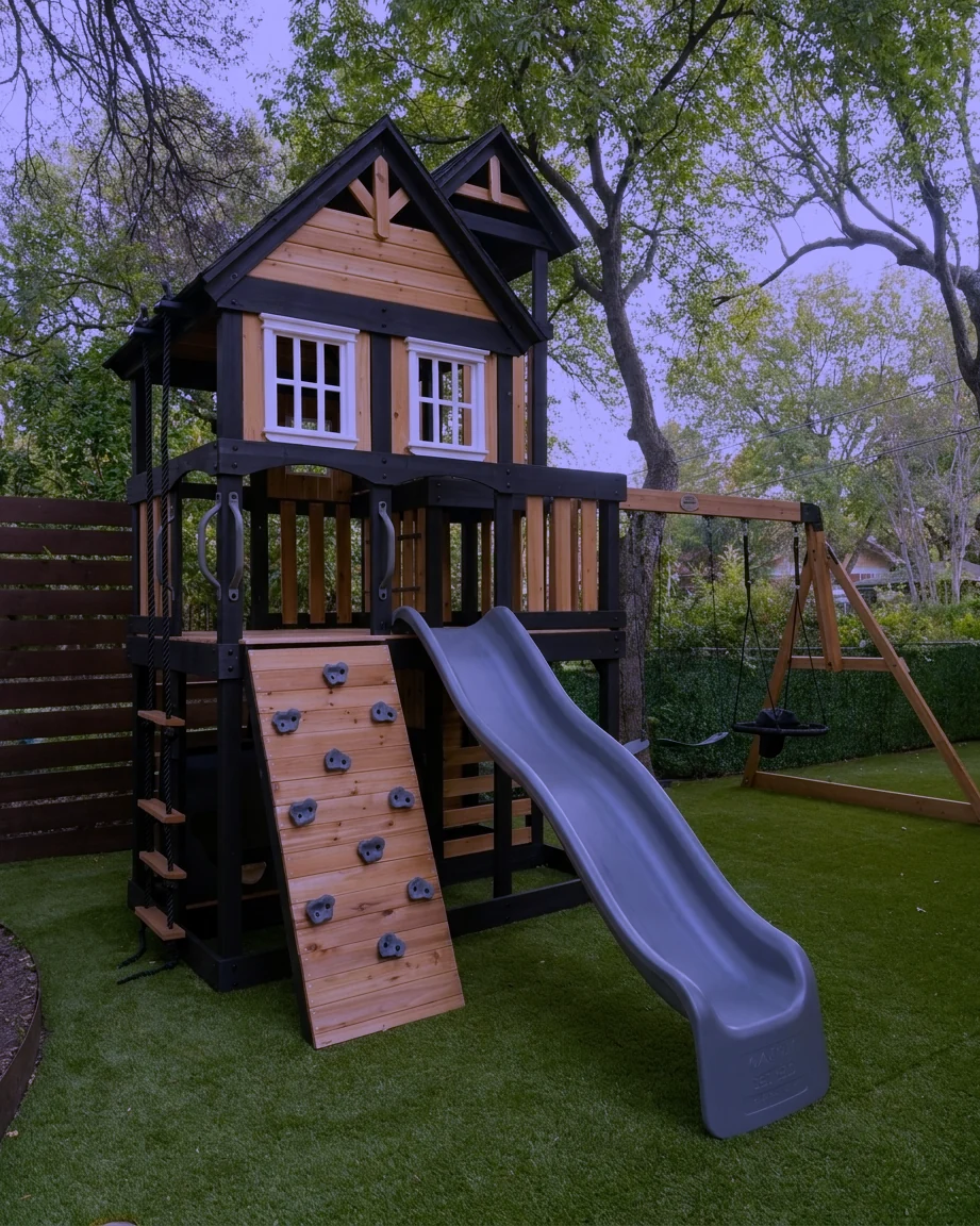 An outdoor play set built and standing in a back yard.