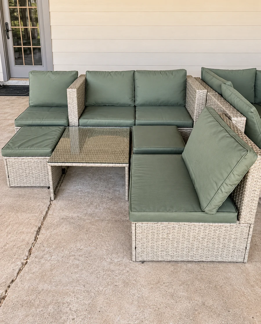 A wicker patio sectional with its cushions, assembled on a patio.